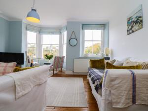 a living room with two beds and a couch at Ferryside Watch in Fowey