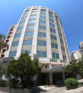 a large white building with a sign on it at Eden Hotel in Beirut