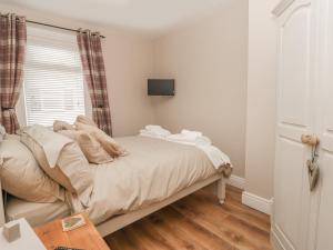 a small bedroom with a bed and a window at The Sanctuary in Redcar