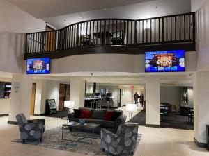 a lobby with a living room with a couch and chairs at Wingate by Wyndham Little Rock in Little Rock