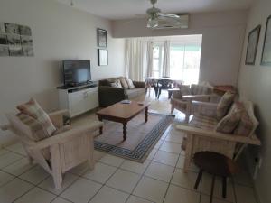 a living room with couches and a coffee table at 9 The Bridge Holiday Resort in St Lucia