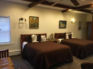 a hotel room with two beds and a window at Lake Pointe Inn in McHenry