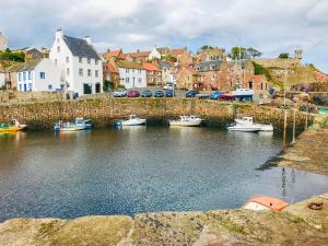a group of boats are docked in a harbor at Sandpipers in Anstruther