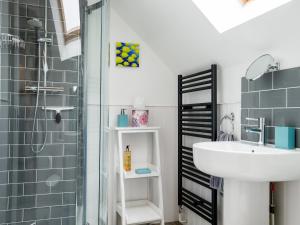 a bathroom with a sink and a shower at Swan Cottage in Arundel +14 photos