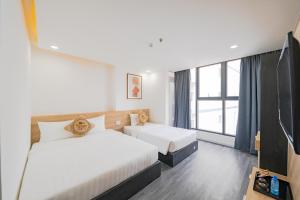 Postel nebo postele na pokoji v ubytování Larosa Hotel Nha Trang + 32 fotografií