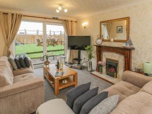 a living room with two couches and a fireplace at Sea Roke in Filey
