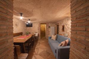 a living room with a blue couch and a table at Chalet Tre Santelle in Bossico