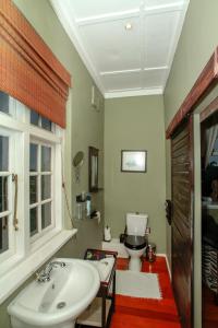 德班的住宿－Acorn B&B，浴室配有白色水槽和卫生间。