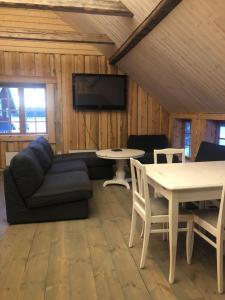 a living room with a couch and a table at Storbo Adventure Camp in Storbo