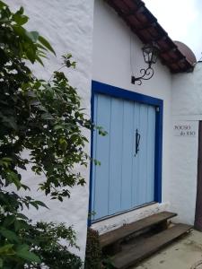 a blue door on the side of a building at Pouso do Rio in Pirenópolis