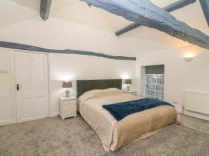 a bedroom with a large bed in a room at The Cottage in Grange Over Sands