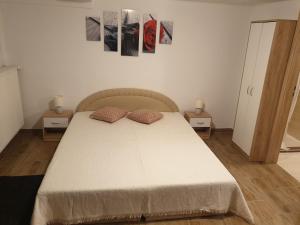 a bedroom with a bed with two night stands and two tables at Ubytovanie v súkromí in Poprad