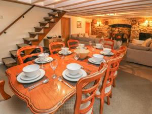 a dining room with a wooden table and chairs at Maerdy Lodge in Haverfordwest