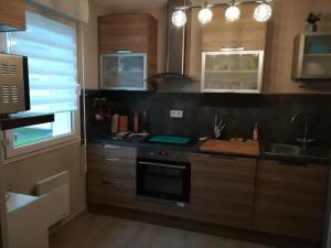 a kitchen with a sink and a stove top oven at maison de vacances baie du Mont Saint Michel in Dol-de-Bretagne