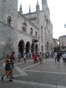 a group of people walking in front of a cathedral at Central Art House in Como