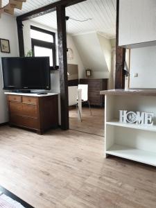 uma sala de estar com uma televisão de ecrã plano sobre uma mesa em Altstadt-Apartment Petershagen em Petershagen