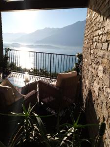 a balcony with chairs and a view of the ocean at Il Giardino Di Lory in Vercana