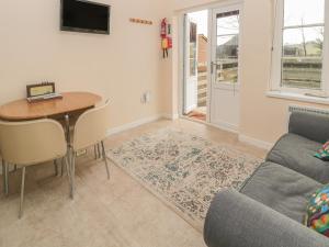 a living room with a table and a couch at Vallum Kiosk in Hexham