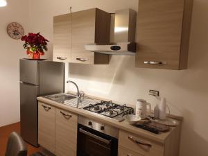 una cucina con piano cottura e frigorifero di 'novecento bed & breakfast ad Acquaviva delle Fonti