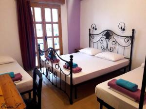 A bed or beds in a room at EVANS Skiathos