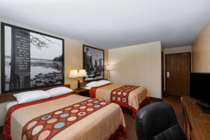A bed or beds in a room at Super 8 by Wyndham Bemidji MN