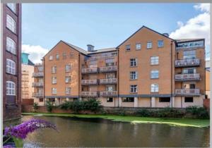 an apartment building next to a body of water at 16 John Walker House in York