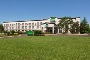 a white building with a lawn in front of it at Wingate By Wyndham Montgomery in Montgomery