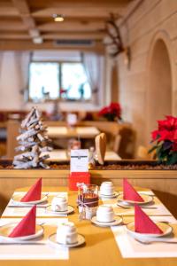 a table with red napkins on top of it at Pension Alpenrose in Maishofen