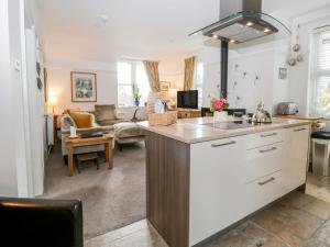 a kitchen with a counter top and a living room at The Bolt Hole in Kendal