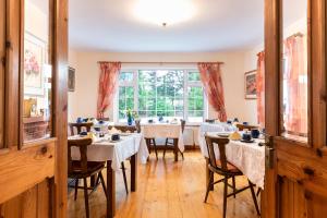 a dining room with tables and chairs and a window at An Bruachan B&B in Kenmare
