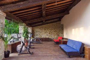 a living room with a blue couch and chairs at Borgo Benedetto in Sansepolcro