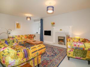 a living room with two couches and a fireplace at 28 Low Shore in Banff