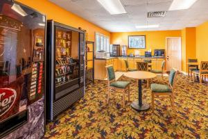a room with a table and chairs and a refrigerator at Econo Lodge Knoxville West - Turkey Creek in Knoxville