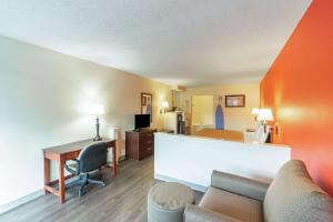 a living room with a couch and a desk at Econo Lodge Laurel in Laurel