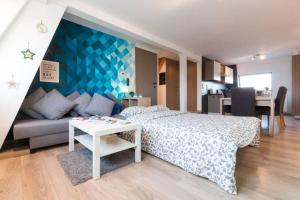 1 dormitorio con cama, sofá y mesa en Duplex appertement met zicht Damse vaart @ Brugge en Brujas