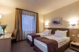 Tempat tidur dalam kamar di Sofia Palace Hotel by HMG