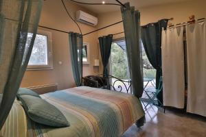 a bedroom with a bed in a room with curtains at Le Mas de Bertagne in Gémenos +68 photos