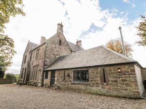 an old stone building with a roof at Stable Cottage in Berwick-Upon-Tweed