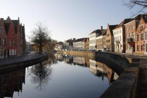 a river in a city with houses and buildings at Spacious Appartment aan damse vaart @ brugge in Bruges