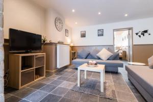 a living room with a couch and a tv at Spacious Appartment aan damse vaart @ brugge in Bruges