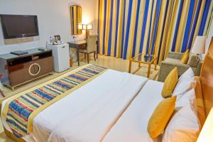 เตียงในห้องที่ City Stay Grand Hotel Apartments - Al Barsha