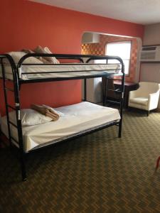 two bunk beds in a room with a mirror at Downtown Value Inn in Portland