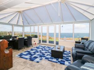 a living room with a view of the ocean at Golygfa Ynys Island View in Amlwch