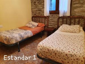 Cama o camas de una habitación en Apartaments Rurals XIX