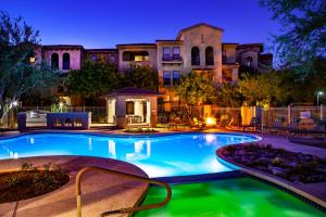 a swimming pool in front of a house at night at Luxury Condos by Meridian CondoResorts- Scottsdale in Scottsdale