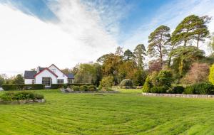 a large yard with a house in the background at An Bruachan B&B in Kenmare