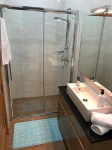 La salle de bains est pourvue d'une douche et d'un lavabo. dans l'établissement The Village Apartment 2, à Kirkop
