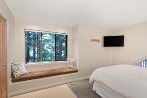 a bedroom with a bed and a window at Forest Trails by Whistler Premier in Whistler