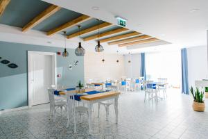 a dining room with tables and chairs and blue walls at Luvi Kaş Otel - Adults Only (+16) in Kaş