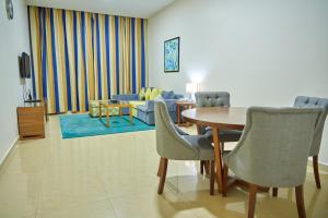 a living room filled with furniture and a table at City Stay Grand Hotel Apartments - Al Barsha in Dubai
